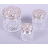 Three silver topped glass dressing table jars