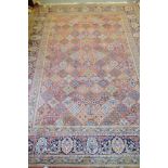 A Persian city garden rug with all-over floral design on a rust ground, in shades of blue, pink,