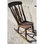 A Windsor splat back rocking chair with elm panel seat