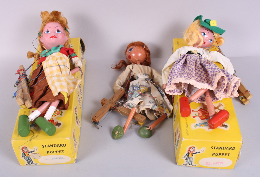 Two standard Pelham puppets, "Mitzi" and "Gretel", in boxes, and another puppet, unboxed