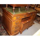 A walnut double pedestal desk with green leather top, fitted nine drawers, on block base, 47 12"