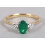 An emerald and diamond dress ring, in yellow metal mount, stamped 18K, ring size M