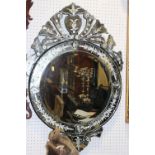 A "Venetian" circular wall mirror, 23" dia, and a smaller similar mirror