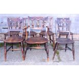 A set of seven 19th century fruitwood spindle and arcade back dining chairs with panel seats, on
