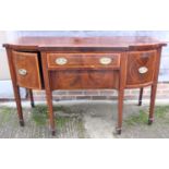 An Edwardian break bowfront mahogany banded sideboard, fitted one drawer over frieze drawer, flanked