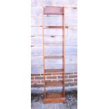 A pitch pine narrow bookcase, 12" wide, an oak nest of three tables, an oak occasional table, on