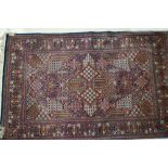 A Kerman city rug with all over garden design and multi borders in shades of red, blue, sand and