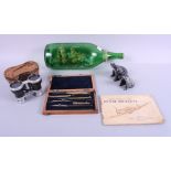 A ship in a bottle, "HMS Shannon", a set of drawing instruments, two stone frogs, a pair of opera
