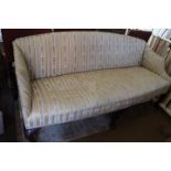 A late Georgian mahogany settee, upholstered in a floral striped fabric, on cabriole supports and