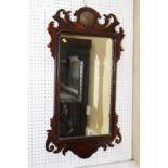 A mahogany framed wall mirror with shell crest, 23" x 12 1/2"