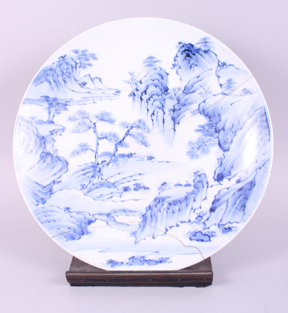 A Chinese blue and white shallow dish, decorated landscape with hills and trees, 14 3/4" dia (
