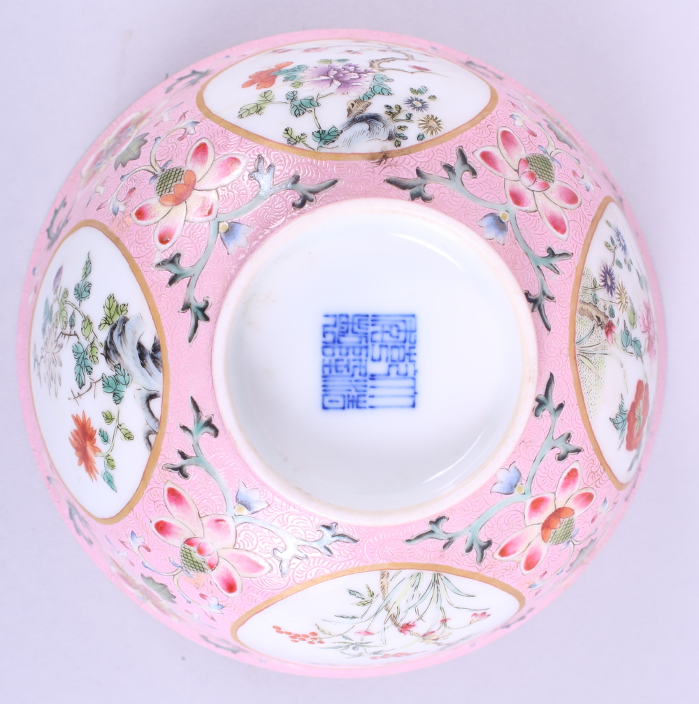 A Chinese porcelain bowl, decorated panels with trees and flowers on a pink ground, inside decorated - Image 3 of 7