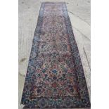 A Persian design runner with all-over Herati type leaf and scroll design, in shades of pink and