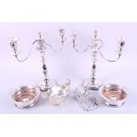 A pair of silver plated two-branch candelabra, a pair of plated bottle coasters, a plated sauce boat