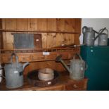Four galvanised watering cans, two cricket bats and various other items