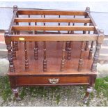 A mahogany canterbury, fitted one drawer, on turned castored supports, 19" wide