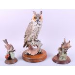 A Capodimonte figure of an owl, 12 1/2" high, on turned wooden base, and two similar bird groups