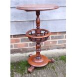 A Victorian walnut circular occasional table with galleried undertier, on three scrolled supports,