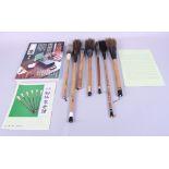 Seven Japanese calligraphy brushes with bamboo handles and calligraphy related catalogues