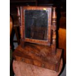 A 19th century figured mahogany swing frame toilet mirror, fitted two drawers, on bun feet, 20"