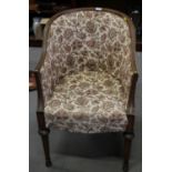 A showframe tub armchair, upholstered in a floral fabric, on turned supports