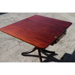 A mahogany drop leaf table, fitted one drawer, on turned column and splayed supports, 22" wide,