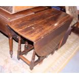 A 19th century oak gateleg table, on turned and square supports, 40 1/2" wide x 17 1/2" deep (damage