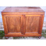 A 19th century mahogany linen press cupboard, the interior fitted trays, enclosed two panel doors,