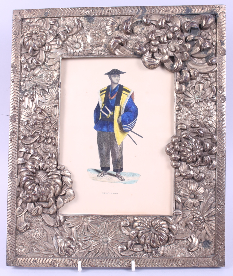 A Japanese silvered picture frame with floral decoration in high relief containing a coloured