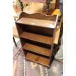 An oak narrow bookcase, on plinth base, 19" high, a mahogany coffee table and a bedside cupboard