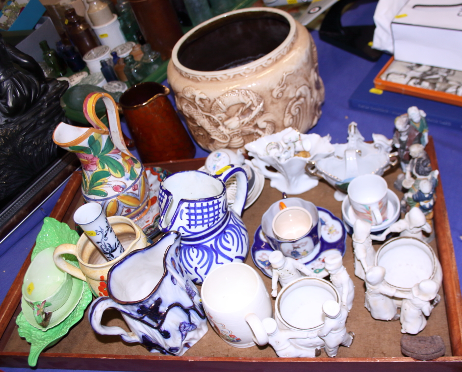 A Bretby jardiniere, decorated dragons, a Carlton ware sauce boat, assorted jugs and other items