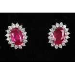 A pair of 18ct white gold ruby ear studs with diamond accents