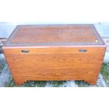 A camphor wood chest with carved floral border, on bracket supports, 35 1/2" wide