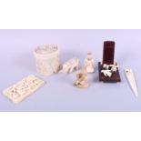 An ivory circular pot and cover, 3" high, an ivory card case, a model elephant and other items