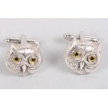 A pair of white metal cufflinks, in the form of owl faces, stamped sterling silver
