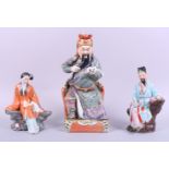 A Chinese figure of a seated scholar, 12" high, a figure of a seated lady, 7 1/2" high, and