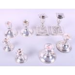 Four pairs of filled silver candlesticks, various