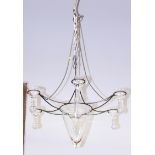A wrought iron six-light chandelier with glass candle holders