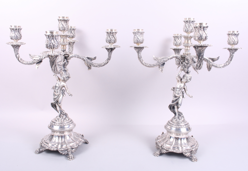 A pair of Portuguese silver five-light candelabra with cherub supports, 16 1/2" high, 183.7oz troy