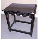 A late 19th century carved and ebonised side table, on turned and stretchered supports, 30" wide,