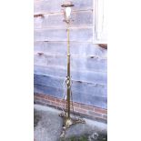 A 20th century brass standard lamp, on tripod support