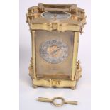 A brass and glass cased repeater carriage clock with silvered dial, Arabic numerals inscribed "E