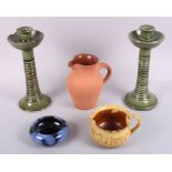 A pair of Ewenny pottery green glazed candlesticks, 9 1/2" high (chips), two jugs and a shallow