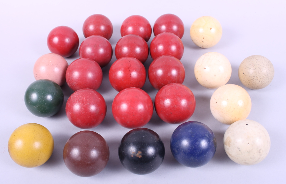 Three ivory billiard balls and a quantity of other billiard balls