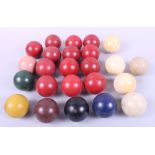 Three ivory billiard balls and a quantity of other billiard balls