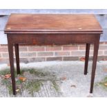A mahogany fold-over card table, on square tapered supports, 33 1/2" wide