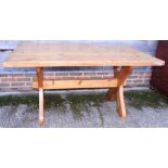 A pine refectory table, on 'X' frame support, and a pine bench, on panel end supports, each 60"