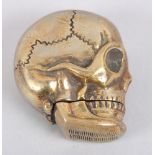 A brass skull-shaped vesta case, 1 1/2" long