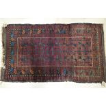 A Caucasian tribal rug with all over geometric design in shades of blue, plum and natural, 62" x 36"