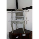 A pair of grey painted cane seat chairs (damages), a grey painted wall shelf and a low armchair,